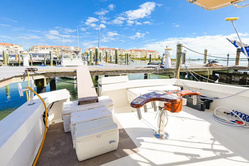 Sue-sea Yacht Photos Pics 1999 Viking 55 Convertible yacht docked at a marina under a clear blue sky.