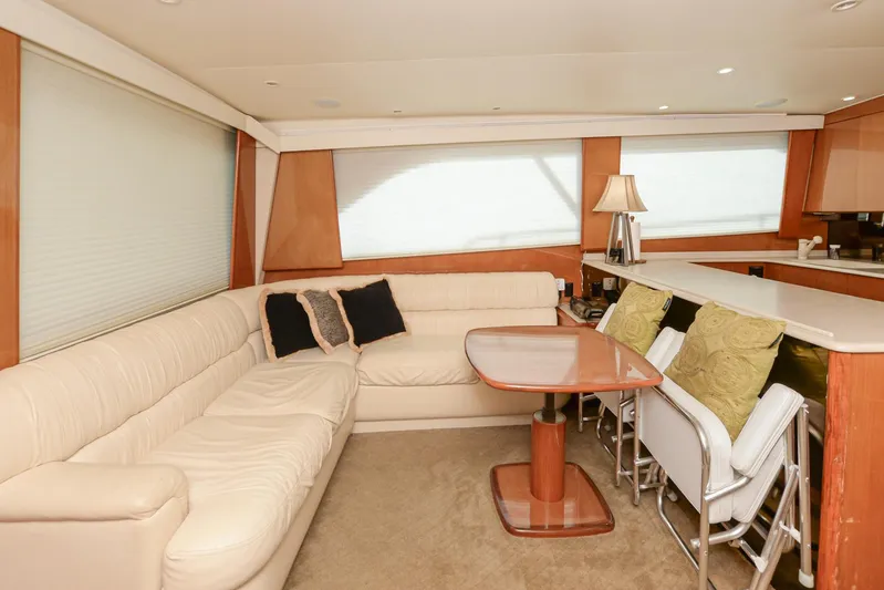 Sue-sea Yacht Photos Pics Interior of 1999 Viking 55 Convertible yacht with beige seating and dining area.