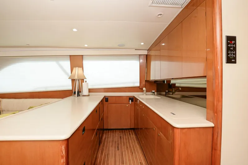 Sue-sea Yacht Photos Pics Luxurious kitchen interior of 1999 Viking 55 Convertible yacht with wooden cabinetry and modern design.