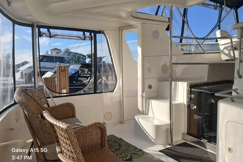  Yacht Photos Pics Interior of 2000 Sea Ray 420 Aft Cabin yacht with wicker chairs and marina view.