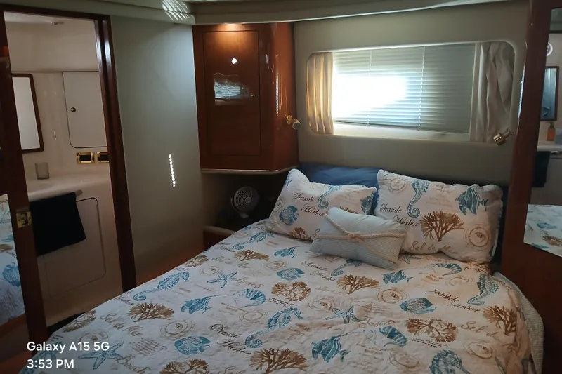  Yacht Photos Pics Cozy bedroom in 2000 Sea Ray 420 Aft Cabin yacht with nautical-themed bedding.