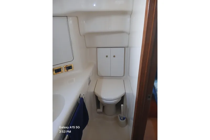  Yacht Photos Pics Bathroom in 2000 Sea Ray 420 Aft Cabin yacht, featuring compact design and storage cabinets.