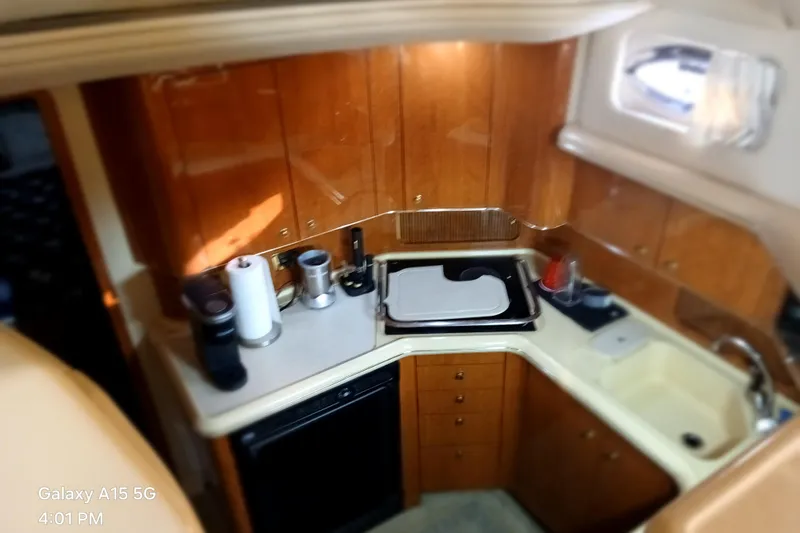  Yacht Photos Pics Interior of 2000 Sea Ray 420 Aft Cabin yacht kitchen with wooden cabinets and appliances.