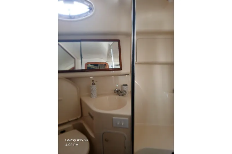  Yacht Photos Pics Bathroom interior of 2000 Sea Ray 420 Aft Cabin yacht with sink and mirror.