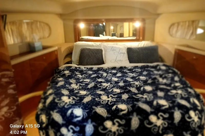  Yacht Photos Pics Cozy bedroom in 2000 Sea Ray 420 Aft Cabin yacht with nautical-themed bedding.