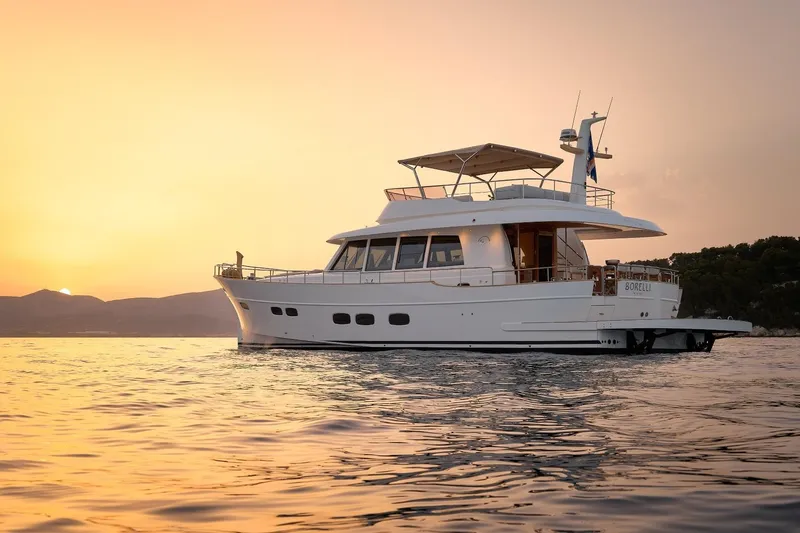 Sasga Yachts 68 Flybridge Yacht Photos Pics 2026 Sasga Yachts Menorquin 68 FB cruising at sunset on calm waters.