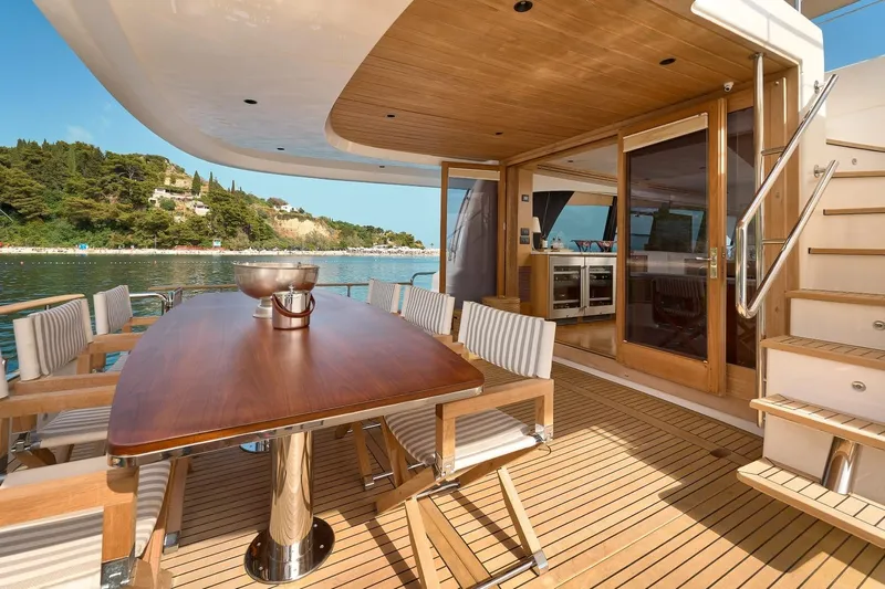 Sasga Yachts 68 Flybridge Yacht Photos Pics Luxurious 2026 Sasga Yachts Menorquin 68 FB deck with elegant dining area and scenic view.