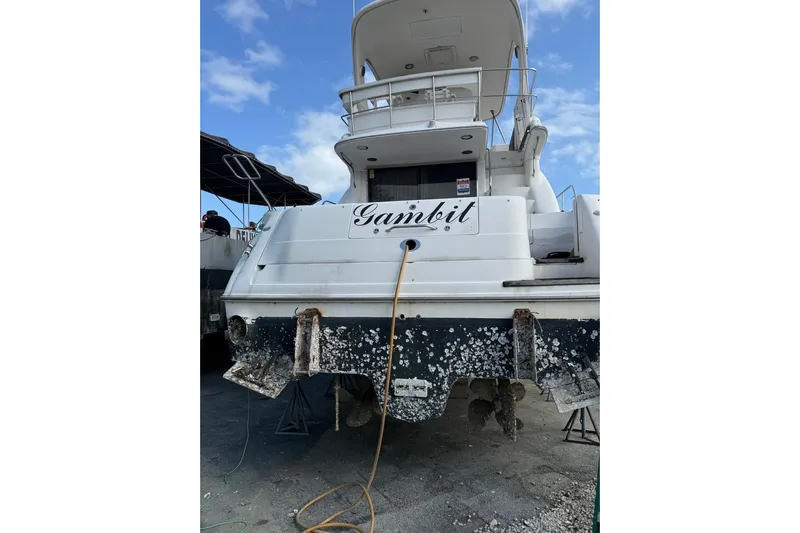 Gambit Yacht Photos Pics 2001 Sea Ray 560 Sedan Bridge yacht on land, showing rear view and name "Gambit."
