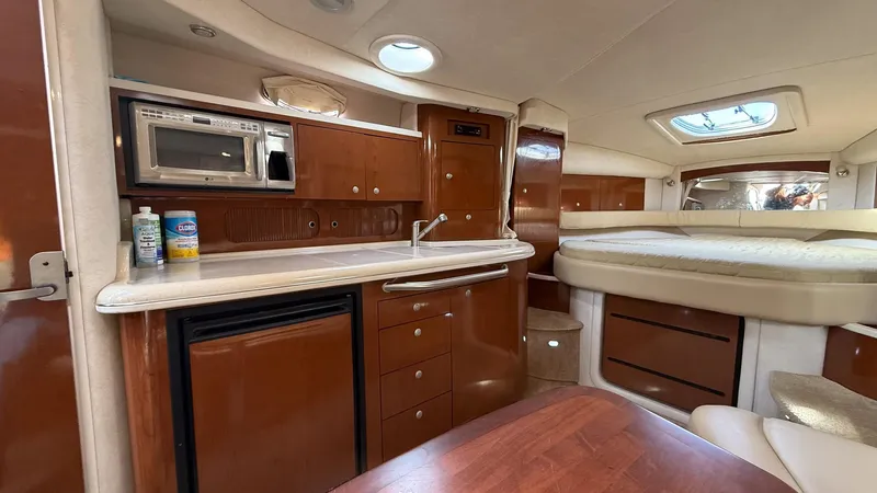  Yacht Photos Pics Interior of 2008 Sea Ray 340 Sundancer yacht with kitchenette and bed.