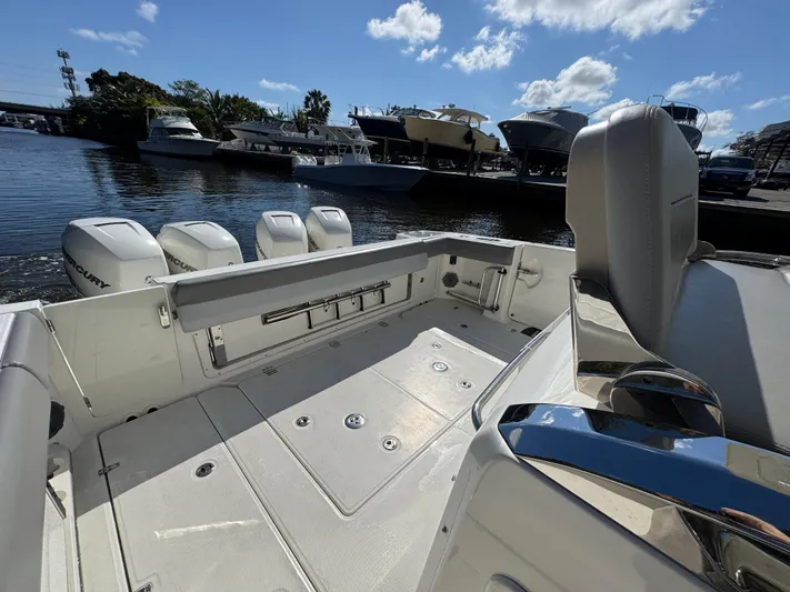  Yacht Photos Pics 2016 Boston Whaler 420 Outrage boat interior with multiple engines, docked near other boats.