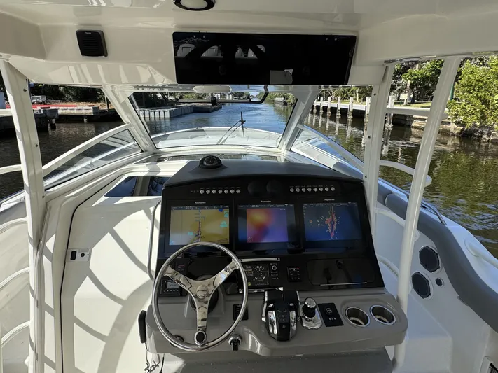  Yacht Photos Pics 2016 Boston Whaler 420 Outrage helm with advanced navigation displays and steering wheel.