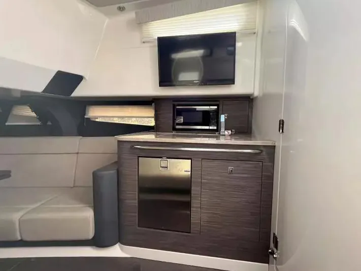  Yacht Photos Pics Interior of 2016 Boston Whaler 420 Outrage with modern kitchenette and seating area.