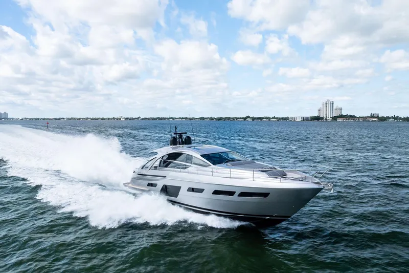 Niki Yacht Photos Pics 2024 Pershing 7X yacht cruising on open water under a partly cloudy sky.