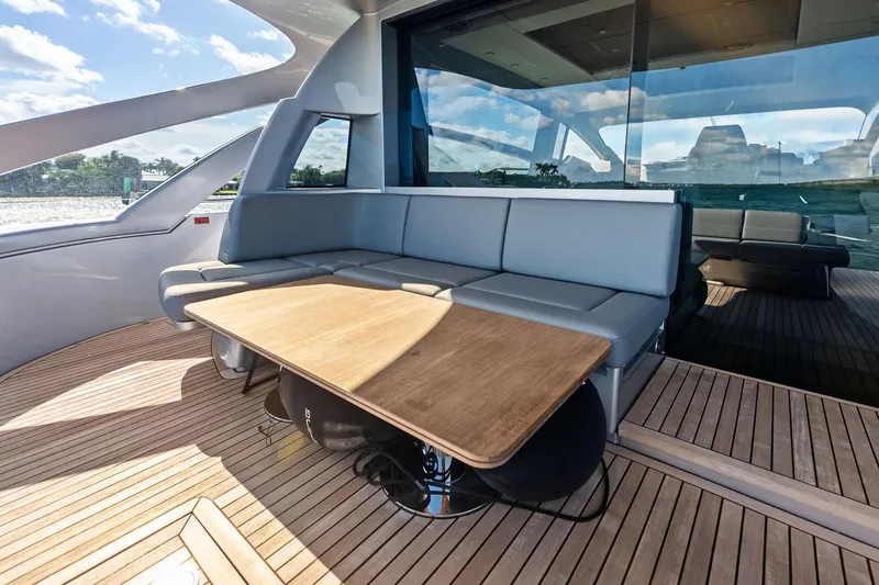 Niki Yacht Photos Pics Luxurious 2024 Pershing 7X yacht interior with sleek seating and wooden table.