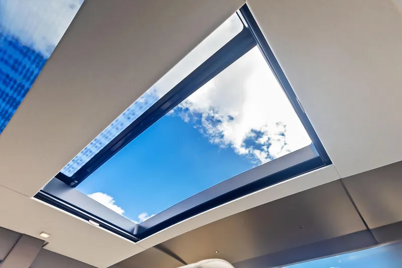 Niki Yacht Photos Pics Skylight view from 2024 Pershing 7X yacht, showcasing blue sky and clouds.
