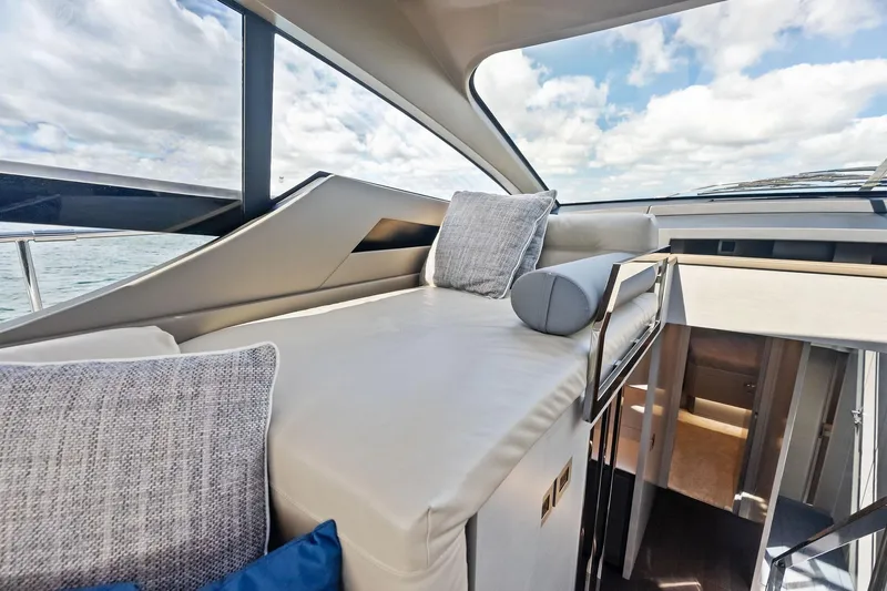 Niki Yacht Photos Pics Luxurious interior of 2024 Pershing 7X yacht with plush seating and panoramic windows.