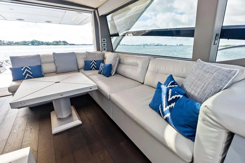 Niki Yacht Photos Pics Luxurious interior of 2024 Pershing 7X yacht with elegant seating and scenic ocean view.