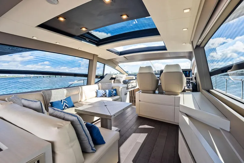 Niki Yacht Photos Pics Luxurious interior of 2024 Pershing 7X yacht with panoramic windows and plush seating.