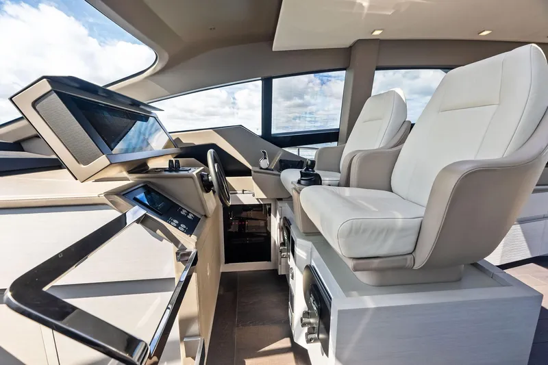 Niki Yacht Photos Pics Luxurious interior of 2024 Pershing 7X yacht with modern helm and plush seating.