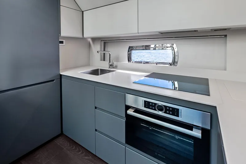 Niki Yacht Photos Pics Modern kitchen interior of 2024 Pershing 7X yacht with sleek appliances and ocean view.