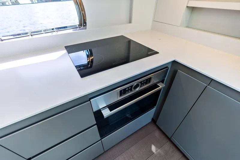Niki Yacht Photos Pics Modern kitchen in 2024 Pershing 7X yacht with sleek appliances and minimalist design.
