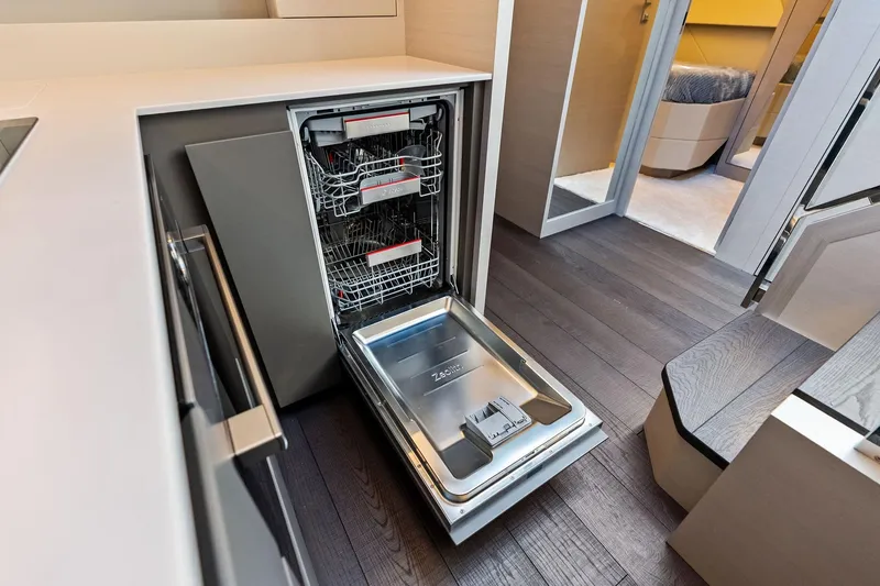 Niki Yacht Photos Pics Modern kitchen with open dishwasher in 2024 Pershing 7X yacht interior.