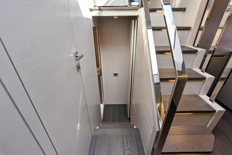 Niki Yacht Photos Pics Interior staircase of 2024 Pershing 7X yacht with modern design and sleek finishes.