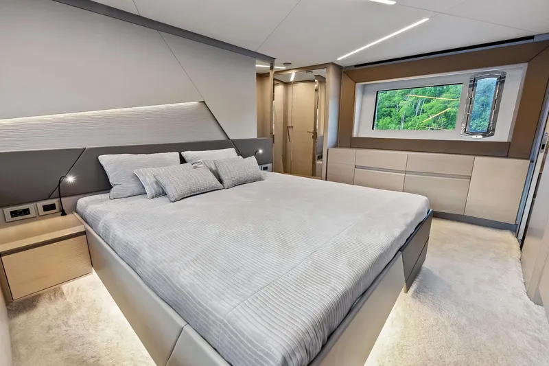 Niki Yacht Photos Pics Luxurious bedroom interior of 2024 Pershing 7X yacht with modern design and large window view.