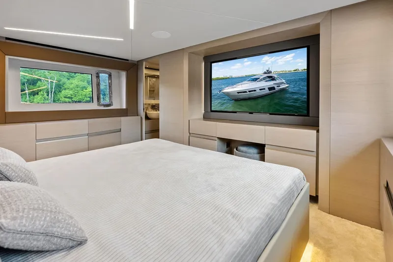 Niki Yacht Photos Pics Luxurious bedroom interior of 2024 Pershing 7X yacht with large window and TV.