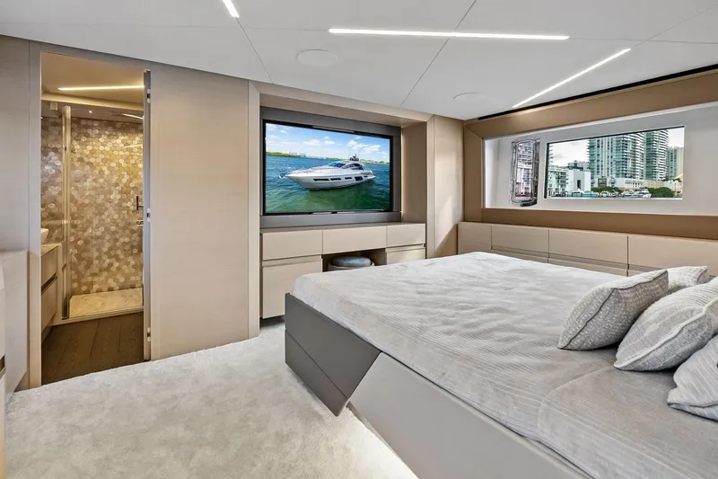 Niki Yacht Photos Pics Luxurious 2024 Pershing 7X yacht bedroom with modern decor and large windows.