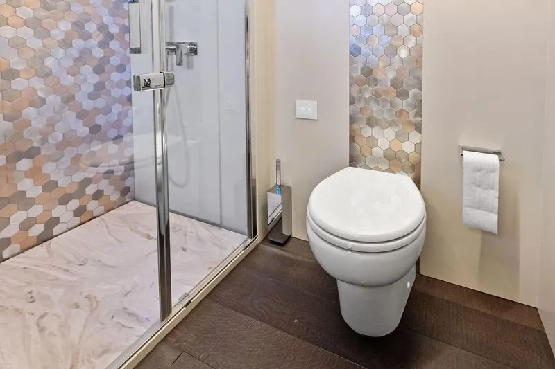 Niki Yacht Photos Pics Luxurious 2024 Pershing 7X yacht bathroom with modern shower and elegant hexagonal tiles.