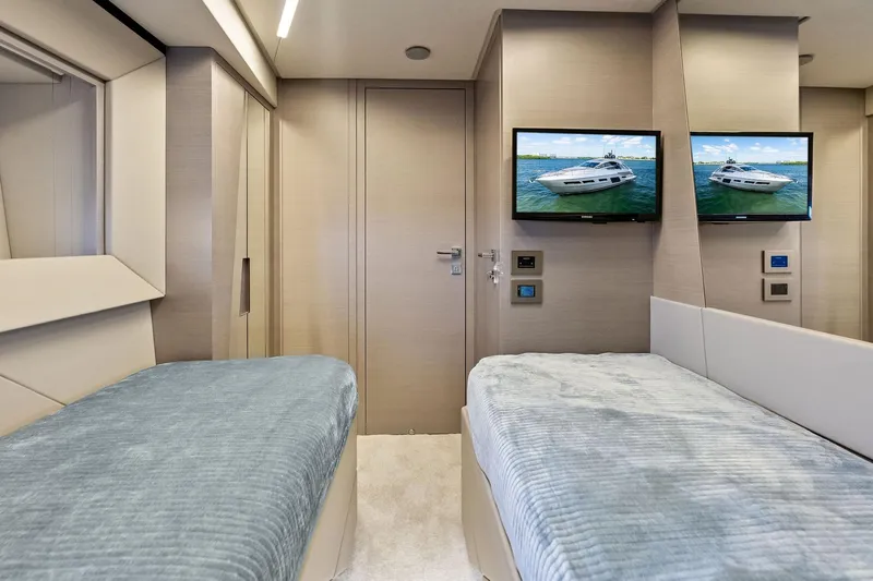 Niki Yacht Photos Pics Luxurious interior of 2024 Pershing 7X yacht with twin beds and dual TVs.