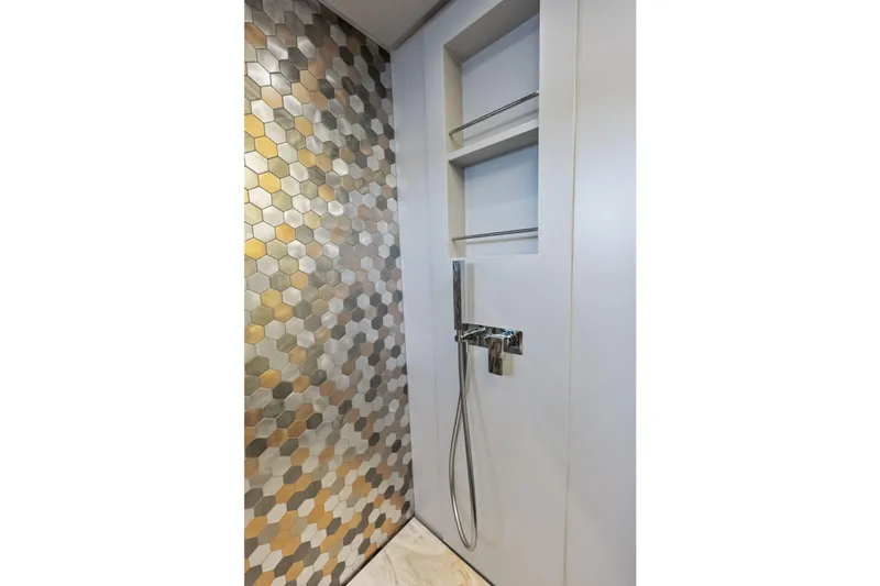 Niki Yacht Photos Pics Luxurious shower with hexagonal tiles in 2024 Pershing 7X yacht bathroom.