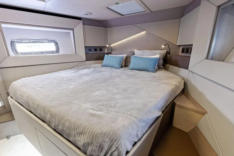 Niki Yacht Photos Pics Luxurious bedroom interior of 2024 Pershing 7X yacht with modern design and cozy bedding.