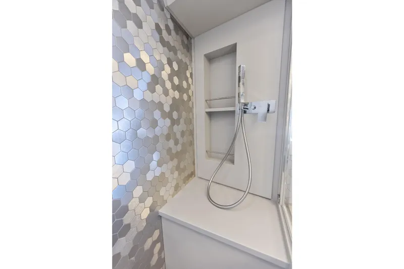 Niki Yacht Photos Pics Modern shower with hexagonal tiles in 2024 Pershing 7X yacht bathroom.