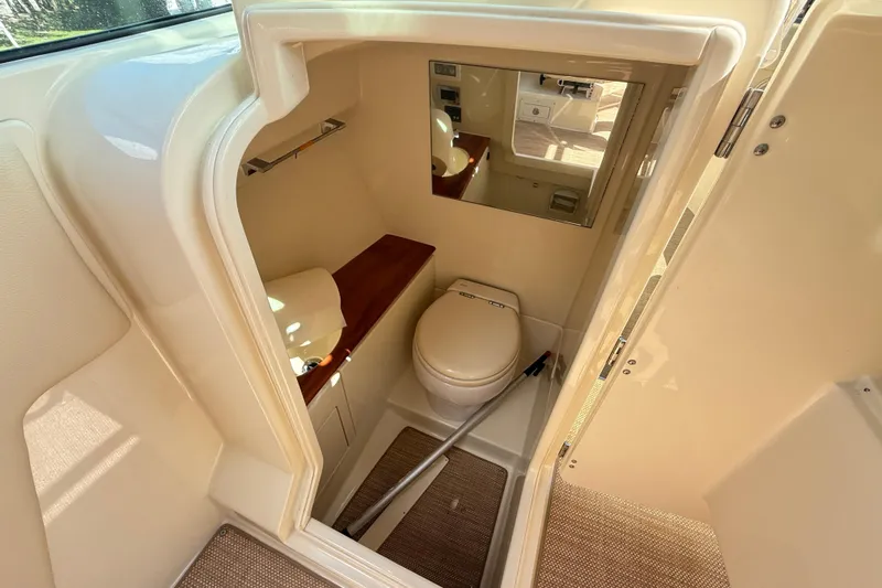  Yacht Photos Pics 2019 Chris-Craft Launch 28 GT boat interior with compact bathroom and mirror.