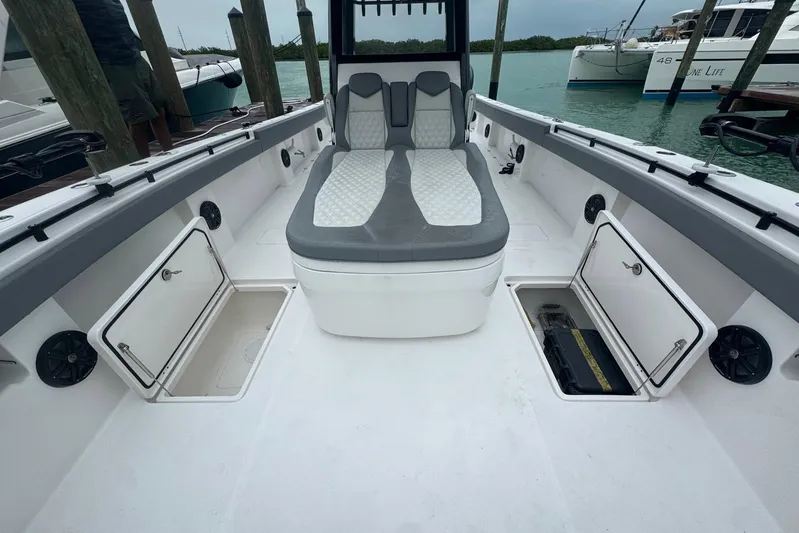  Yacht Photos Pics 2025 Invincible 35 Catamaran interior with seating and open storage compartments.