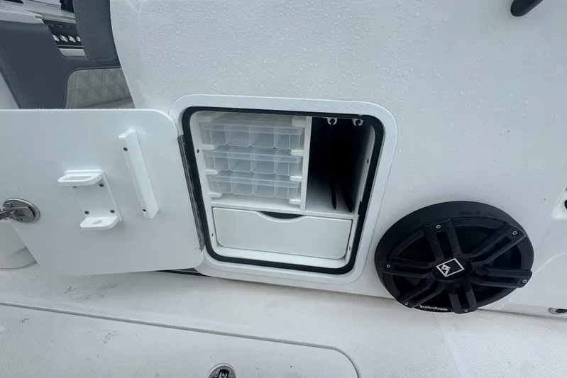  Yacht Photos Pics 2025 Invincible 35 Catamaran storage compartment with organizer and speaker detail.