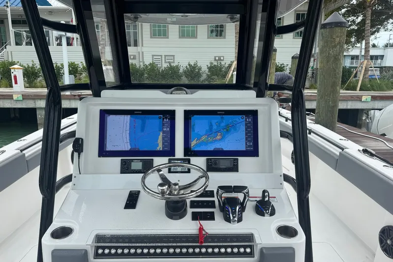  Yacht Photos Pics 2025 Invincible 35 Catamaran helm with dual navigation screens and controls at dock.