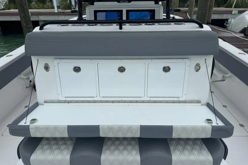  Yacht Photos Pics 2025 Invincible 35 Catamaran interior with storage compartments and cushioned seating.