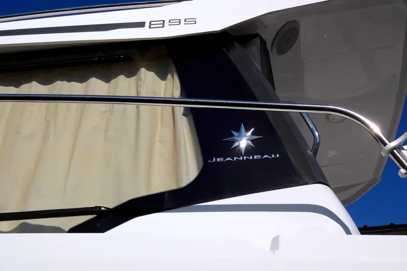 Blue Baby Yacht Photos Pics 2022 Jeanneau Merry Fisher 895 Offshore boat exterior with logo and railing.