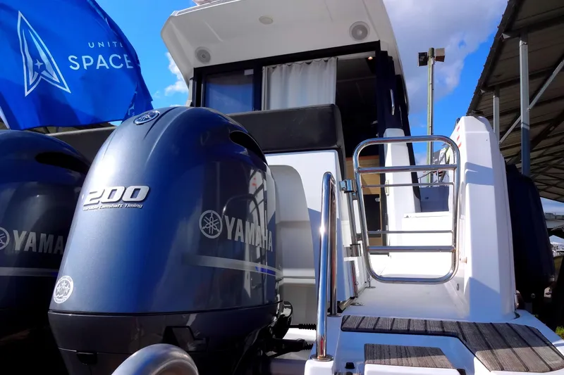 Blue Baby Yacht Photos Pics 2022 Jeanneau Merry Fisher 895 Offshore with Yamaha engines and United Space flag.