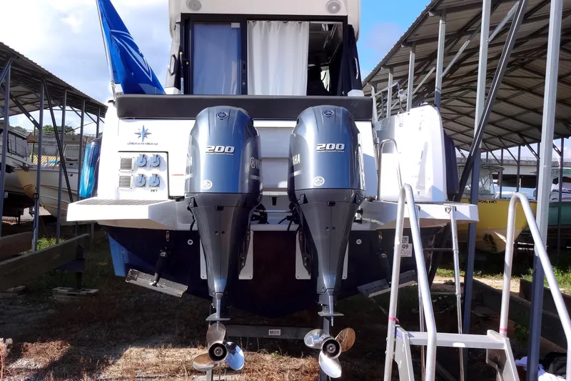 Blue Baby Yacht Photos Pics 2022 Jeanneau Merry Fisher 895 Offshore with dual Yamaha 200 engines in a covered marina.