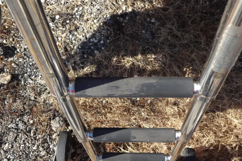 Blue Baby Yacht Photos Pics Stainless steel boat ladder on dry grass, Jeanneau Merry Fisher 895 Offshore, 2022.