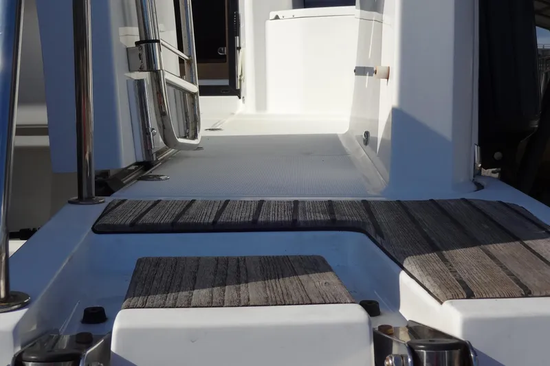 Blue Baby Yacht Photos Pics 2022 Jeanneau Merry Fisher 895 Offshore boat deck with wood accents and stainless steel railings.