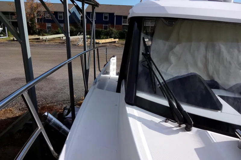 Blue Baby Yacht Photos Pics 2022 Jeanneau Merry Fisher 895 Offshore docked, showcasing sleek design and spacious deck.