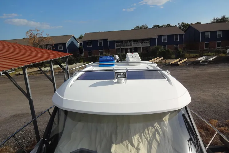 Blue Baby Yacht Photos Pics 2022 Jeanneau Merry Fisher 895 Offshore boat docked near residential area.