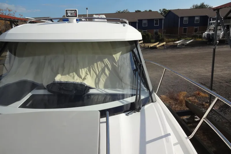 Blue Baby Yacht Photos Pics 2022 Jeanneau Merry Fisher 895 Offshore boat docked, front view with windshield and railings.