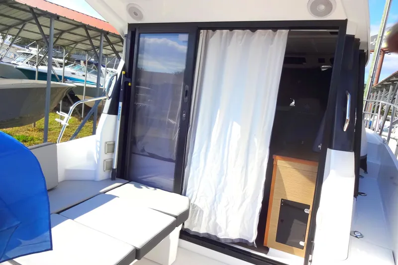 Blue Baby Yacht Photos Pics 2022 Jeanneau Merry Fisher 895 Offshore boat with sliding door and outdoor seating.