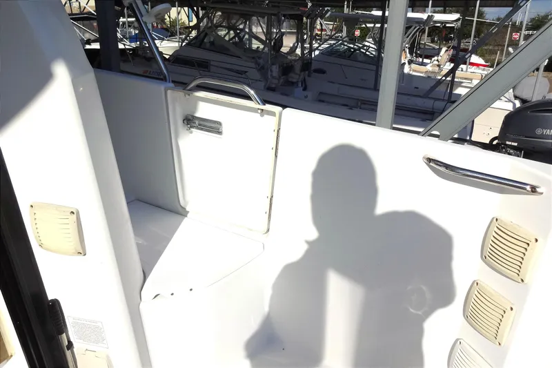Blue Baby Yacht Photos Pics 2022 Jeanneau Merry Fisher 895 Offshore boat interior with shadow and docked vessels.